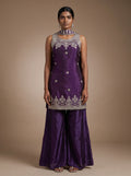 Model wearing violet tissue silk zari embroidered sharara set with matching dupatta