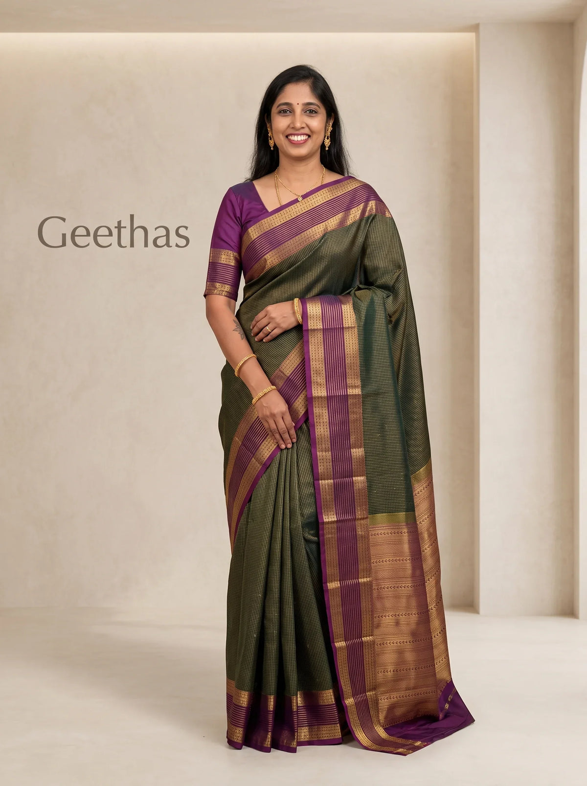 Model wearing a deep green soft silk saree with a purple contrast border and woven gold-toned detailing