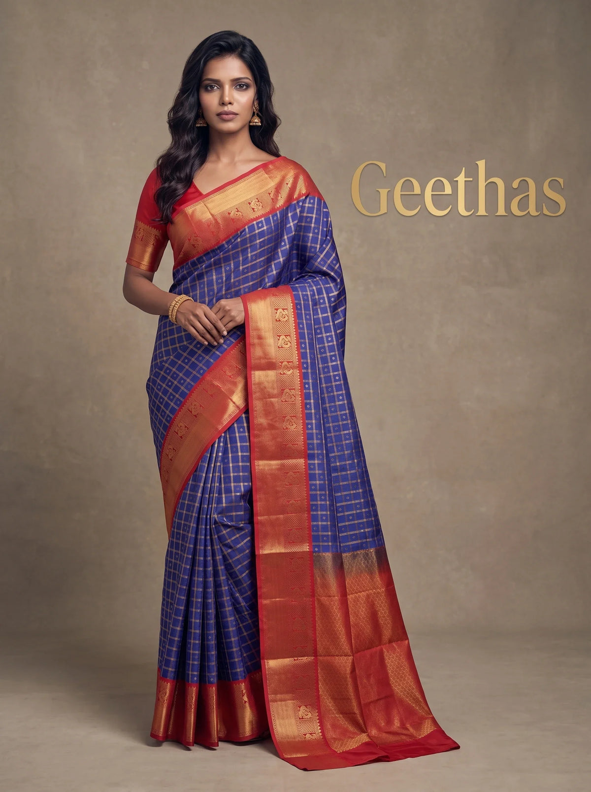 Model wearing royal blue soft silk saree with gold-toned grid pattern, red border and matching pallu