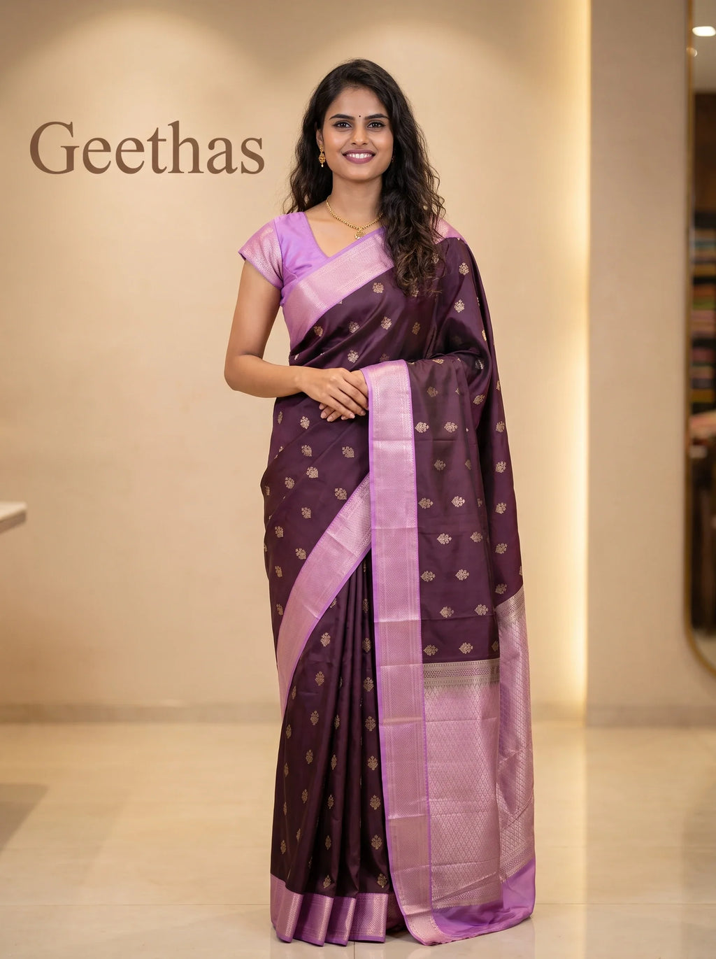 Model wearing deep brown soft silk saree with gold-toned motifs and contrasting lilac border