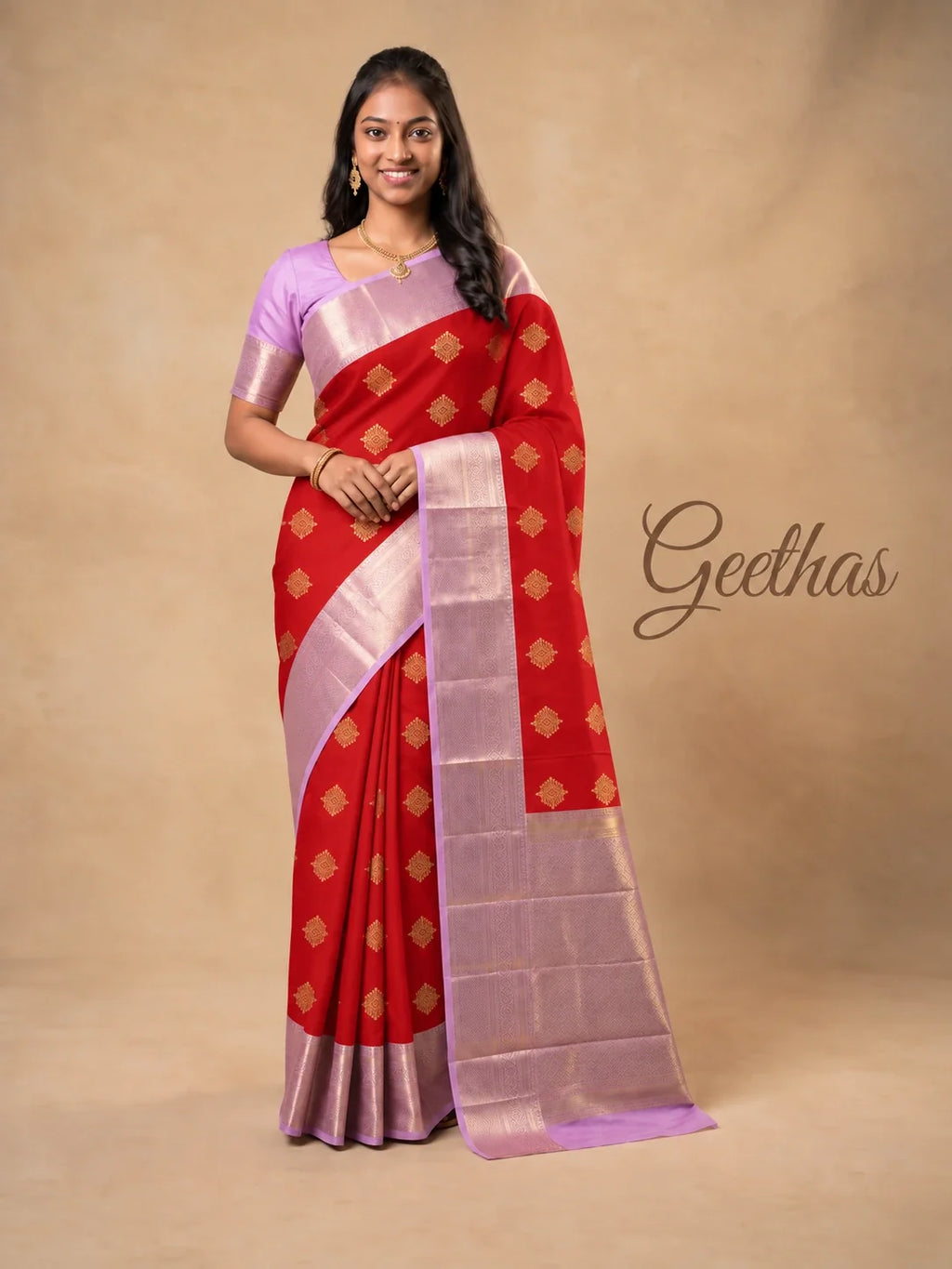 Model wearing a red soft silk saree with gold-toned motifs and a lavender-pink woven border