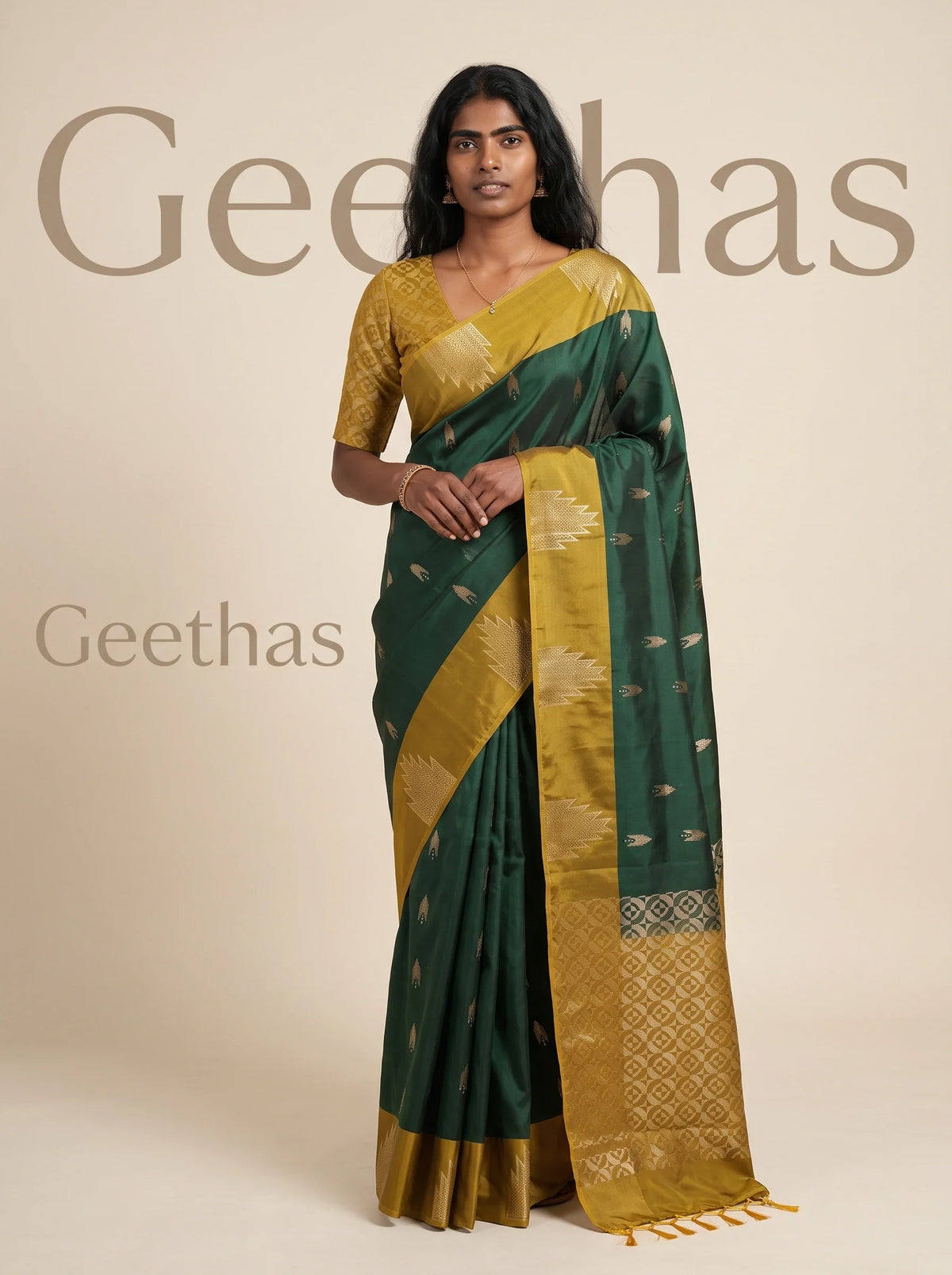 Model wearing an emerald green soft silk saree with gold-toned woven motifs and mustard-gold geometric border